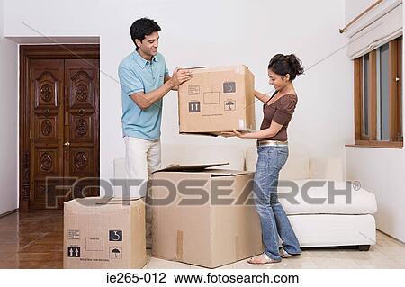 Stock Image - A couple lifting boxes. Fotosearch