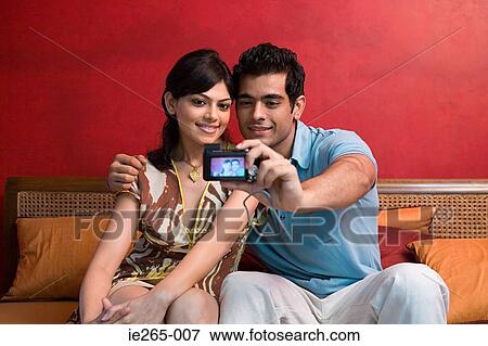 Stock Photo - A couple photographing themselves. Fotosearch