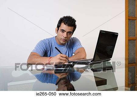 A man sorting his finances on a laptop View Large Photo Image Stock Image - A man sorting his finances on a laptop. Fotosearch