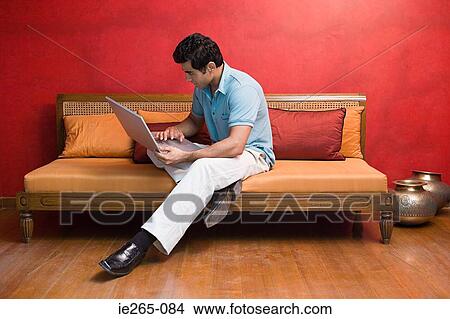 A man using a laptop View Large Photo Image Picture - A man using a laptop. Fotosearch