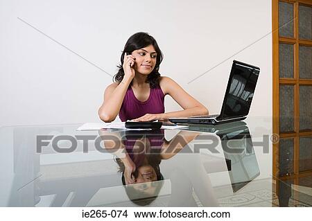 A woman sorting out her finances View Large Photo Image Picture - A woman sorting out her finances. Fotosearch