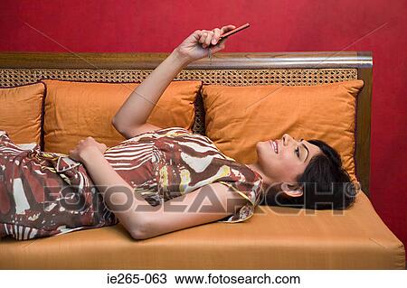 A woman using a cell phone View Large Photo Image Stock Image - A woman using a cell phone. Fotosearch