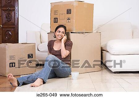 A woman using a cell phone View Large Photo Image Stock Photo - A woman using a cell phone. Fotosearch