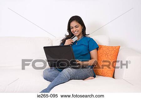 Stock Photography - A young woman using a laptop. Fotosearch