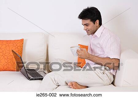 Stock Image - Man using a laptop. Fotosearch