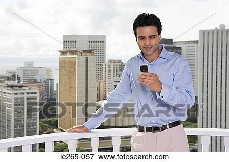 Man using cell phone View Large Photo Image Stock Photo - Man using cell phone. Fotosearch