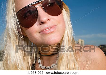 Blond woman wearing sunglasses View Large Photo Image Stock Photograph - Blond woman wearing sunglasses. Fotosearch