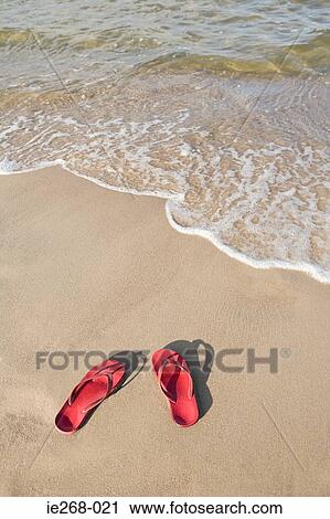 Stock Image - Flip flops on a beach. Fotosearch