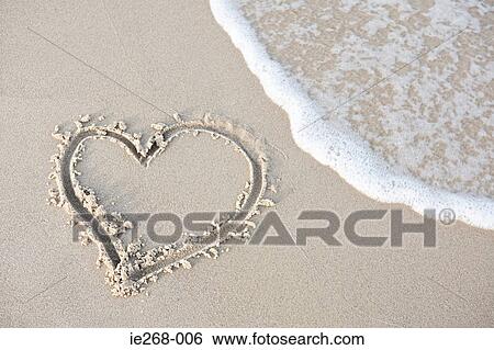 Stock Photograph - Heart shape in the sand. Fotosearch
