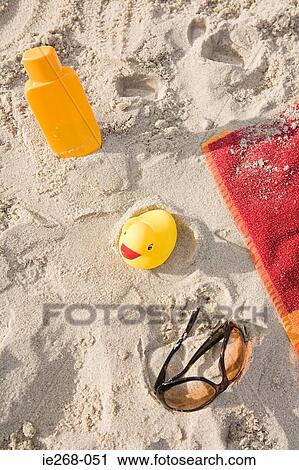 Holiday items on a beach View Large Photo Image Stock Image - Holiday items on a beach. Fotosearch