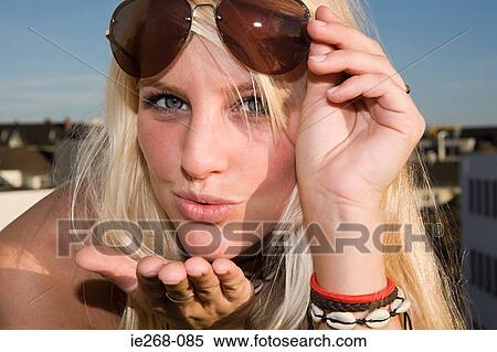 Young woman blowing a kiss View Large Photo Image Stock Photography - Young woman blowing a kiss. Fotosearch