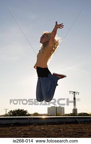 Young woman jumping for joy View Large Photo Image Picture - Young woman jumping for joy. Fotosearch