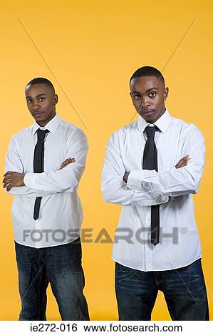 Twin brothers with crossed arms View Large Photo Image Stock Photograph - Twin brothers with crossed arms. Fotosearch