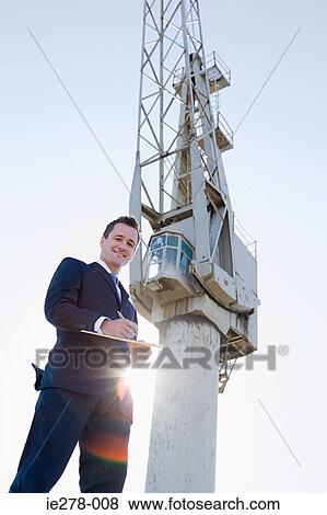Businessman by crane View Large Photo Image Stock Photo - Businessman by crane. Fotosearch