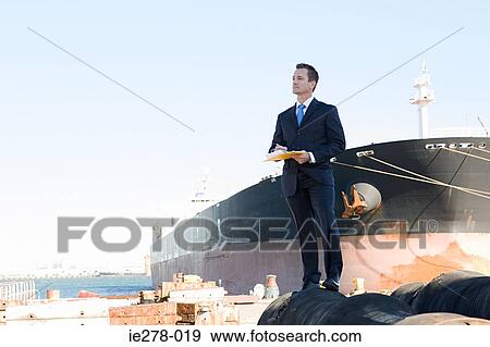 Businessman by ship View Large Photo Image Stock Photo - Businessman by ship. Fotosearch