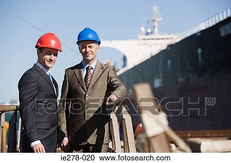 Stock Image - Engineer at harbour. Fotosearch