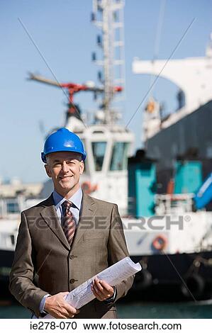 Stock Image - Engineer at harbour. Fotosearch
