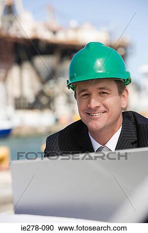 Stock Image - Engineer at harbour. Fotosearch