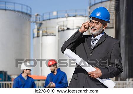 Engineer on cellphone View Large Photo Image Stock Image - Engineer on cellphone. Fotosearch