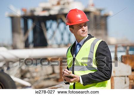 Engineer with handheld computer View Large Photo Image Stock Photo - Engineer with handheld computer. Fotosearch