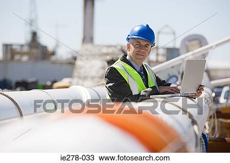 Engineer with laptop View Large Photo Image Stock Image - Engineer with laptop. Fotosearch