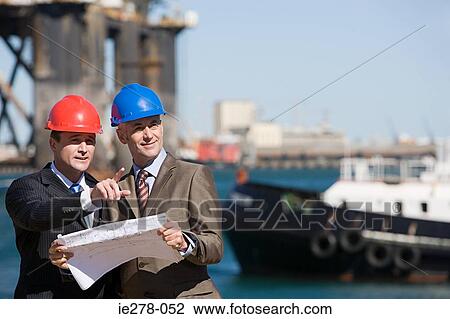 Stock Image - Engineers at harbour. Fotosearch