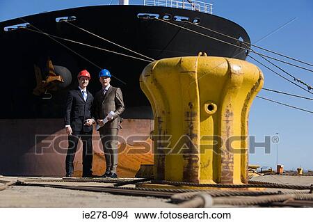 Engineers by ship View Large Photo Image Picture - Engineers by ship. Fotosearch