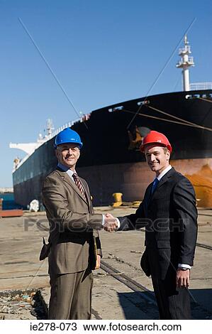 Engineers shaking hands View Large Photo Image Stock Image - Engineers shaking hands. Fotosearch
