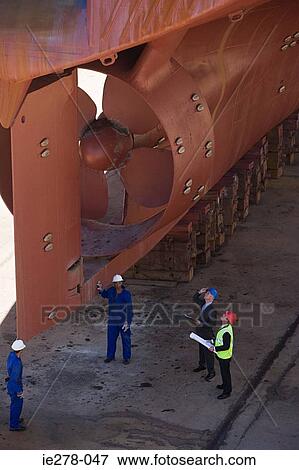 Workers looking at ship View Large Photo Image Stock Photo - Workers looking at ship. Fotosearch