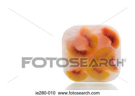 Stock Image - Frozen peaches. Fotosearch