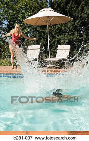 A couple having fun in a swimming pool View Large Photo Image Stock Photo - A couple having fun in a swimming pool. Fotosearch