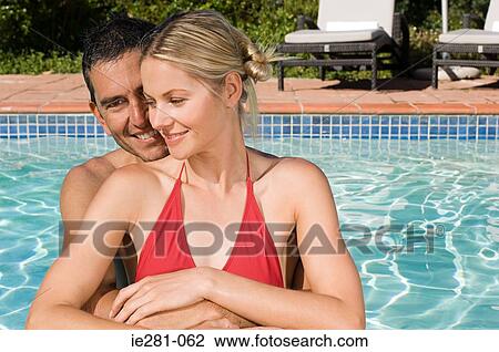 Stock Image - A couple in a swimming pool. Fotosearch