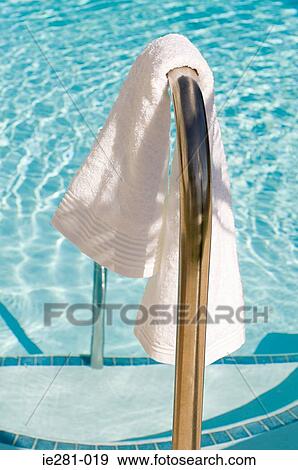 A towel next to a swimming pool View Large Photo Image Stock Photo - A towel next to a swimming pool. Fotosearch