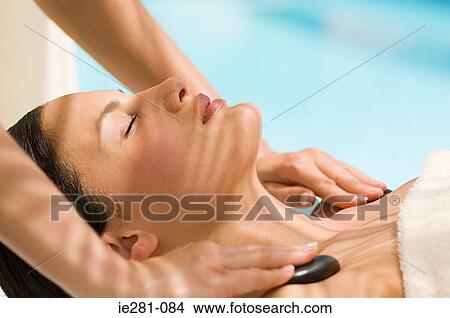 A woman having stone therapy View Large Photo Image Picture - A woman having stone therapy. Fotosearch