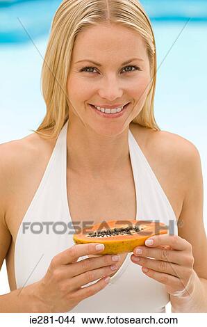 A woman holding a papaya View Large Photo Image Picture - A woman holding a papaya. Fotosearch