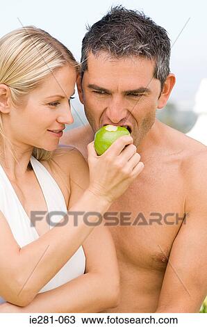 Couple sharing an apple View Large Photo Image Stock Image - Couple sharing an apple. Fotosearch