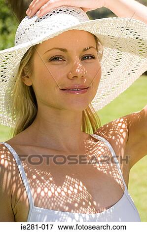 Portrait of a woman wearing a sun hat View Large Photo Image Stock Photo - Portrait of a woman wearing a sun hat. Fotosearch
