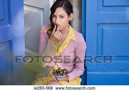 Italian woman eating a bowl of olives View Large Photo Image Stock Photo - Italian woman eating a bowl of olives. Fotosearch