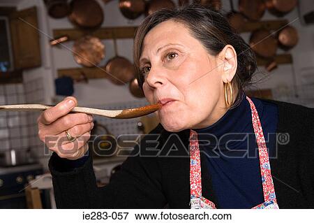 Stock Photo - Italian woman sampling food. Fotosearch