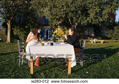 Mother and daughter having lunch in garden View Large Photo Image Stock Image - Mother and daughter having lunch in garden. Fotosearch