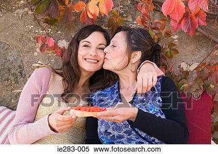 Mother and daughter holding a slice of bruschetta View Large Photo Image Stock Photography - Mother and daughter holding a slice of bruschetta. Fotosearch