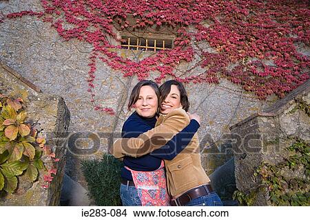 Mother and daughter hugging View Large Photo Image Picture - Mother and daughter hugging. Fotosearch