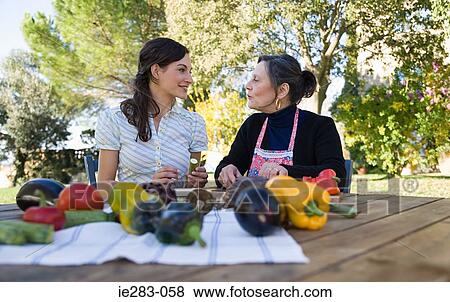 Mother and daughter preparing lunch View Large Photo Image Stock Photo - Mother and daughter preparing lunch. Fotosearch