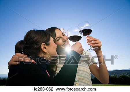 Mother and daughter toasting with red wine View Large Photo Image Stock Image - Mother and daughter toasting with red wine. Fotosearch