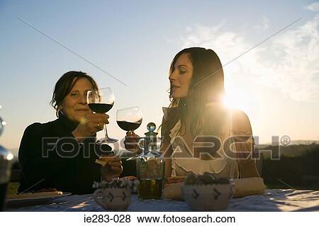 Mother and daughter toasting with red wine View Large Photo Image Stock Photo - Mother and daughter toasting with red wine. Fotosearch