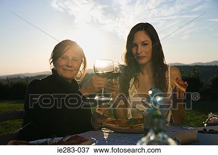 Mother and daughter toasting with red wine View Large Photo Image Stock Photo - Mother and daughter toasting with red wine. Fotosearch