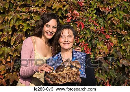Mother and daughter with basket of mushrooms View Large Photo Image Stock Image - Mother and daughter with basket of mushrooms. Fotosearch