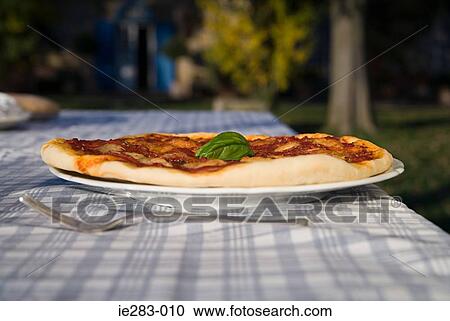 Stock Image - Pizza on an outside table. Fotosearch