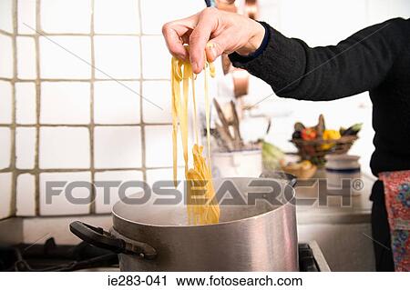 Woman cooking pasta View Large Photo Image Stock Image - Woman cooking pasta. Fotosearch