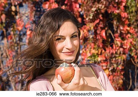 Stock Photograph - Woman eating an apple. Fotosearch